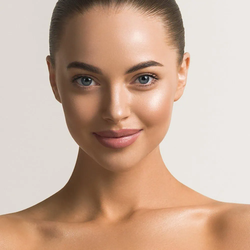 Close-up portrait of a woman with smooth skin and sleek hairstyle, highlighting reduce wrinkles services at Mind x Body Sculpt in Highland, MD